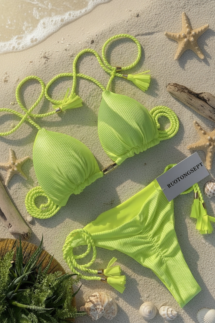 Neon green bikini set with matching rope details on a light gray surface, featuring a brand tag.